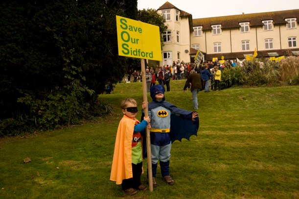 Batman and Robin (unmasked as Jake and Oscar) fly in to save the Knowle